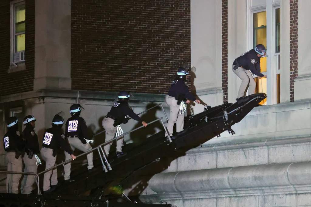 NYPD officers ascend into an opened window at Columbia Universitys  Hamilton Hall in order to clear out occupying protesters.